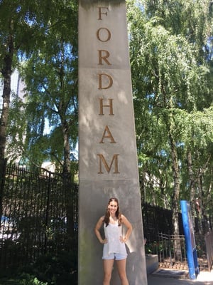 Author Brielle Cayer in front of Fordham sign