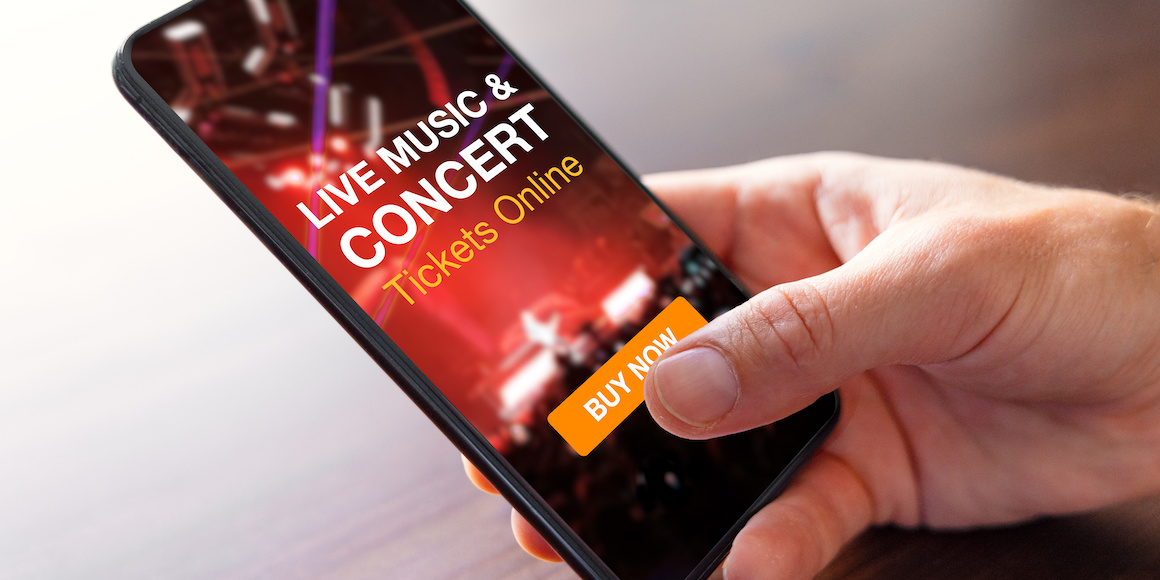 Person purchasing live music and concert tickets online on mobile phone with buy now button