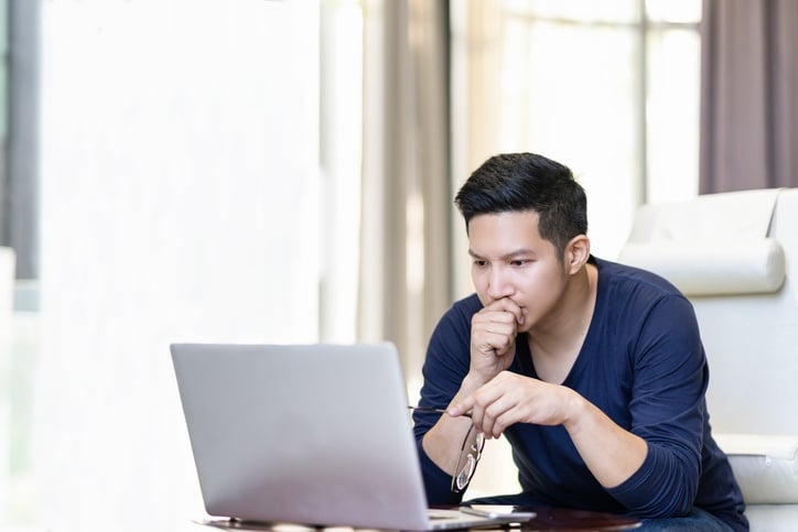 Person reviewing a university homepage on a laptop