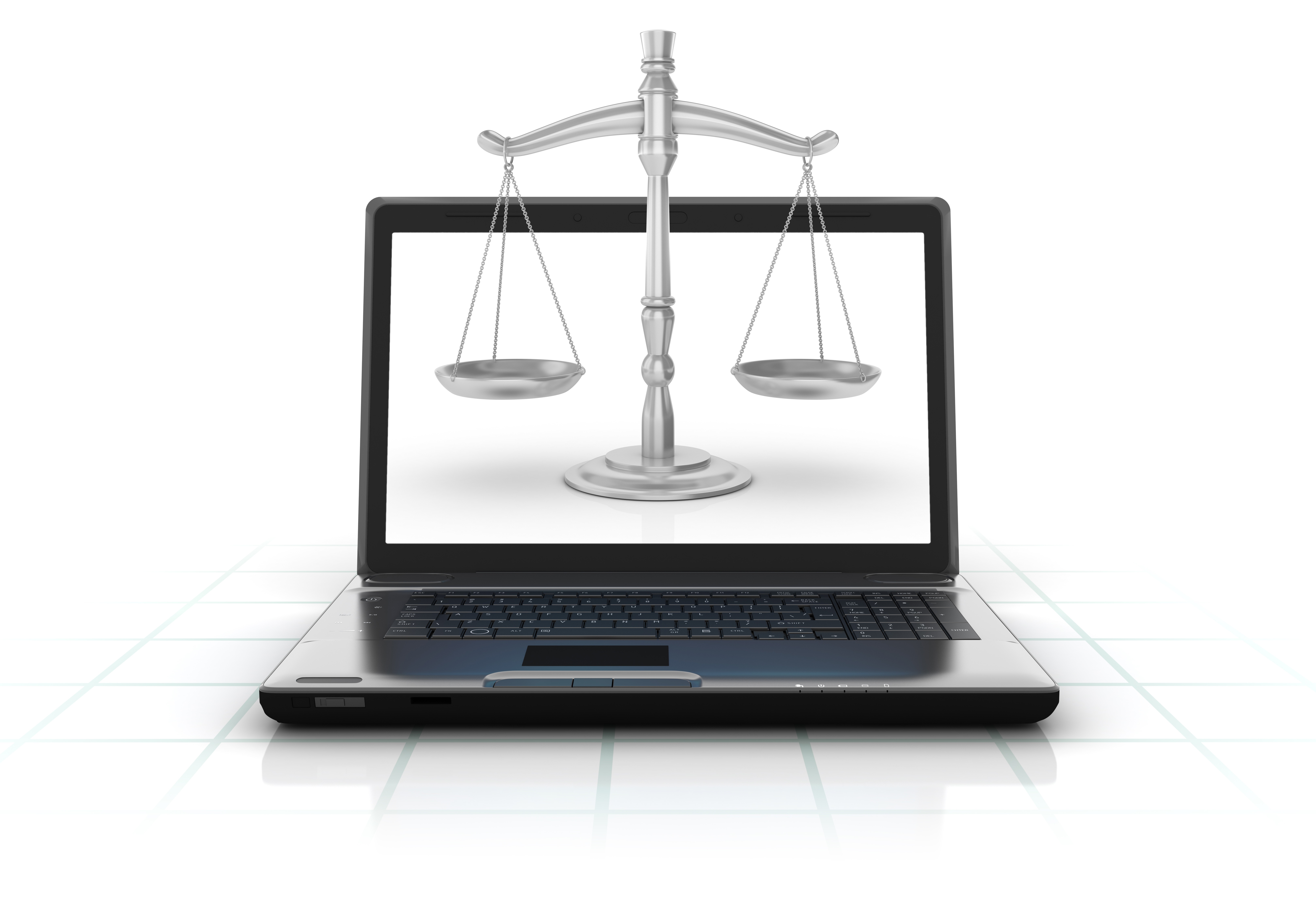 scales of justice in front of a computer monitor 