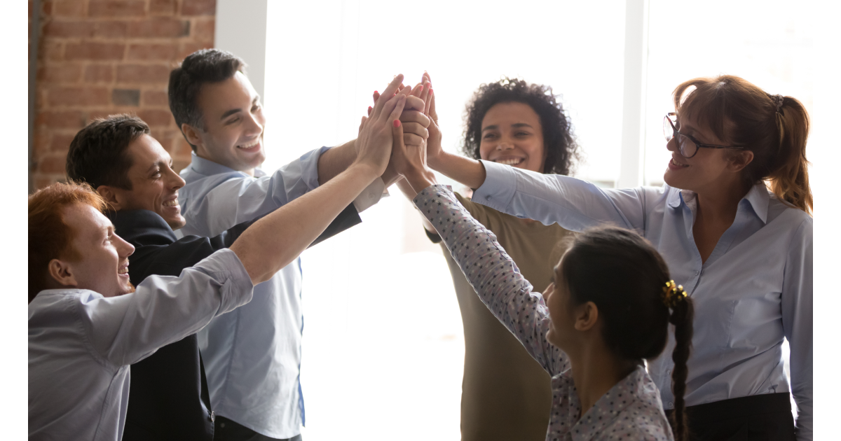 Overjoyed multi racial businesspeople succeed goal giving high five feels excited. Successful corporate team congratulating each other with victory achievement hold hands together show spirit of unity