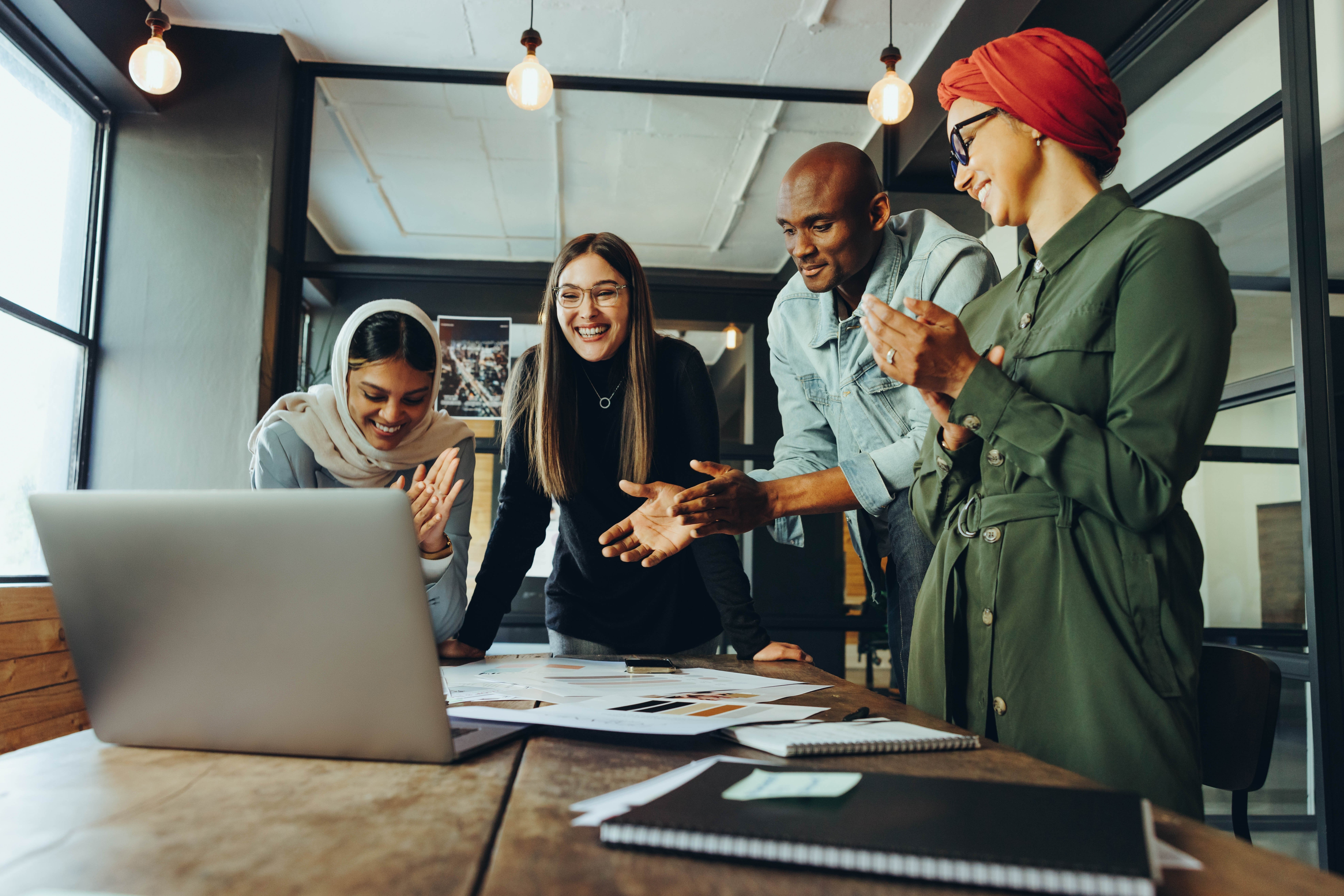 An Accessibility team gathered around a computer